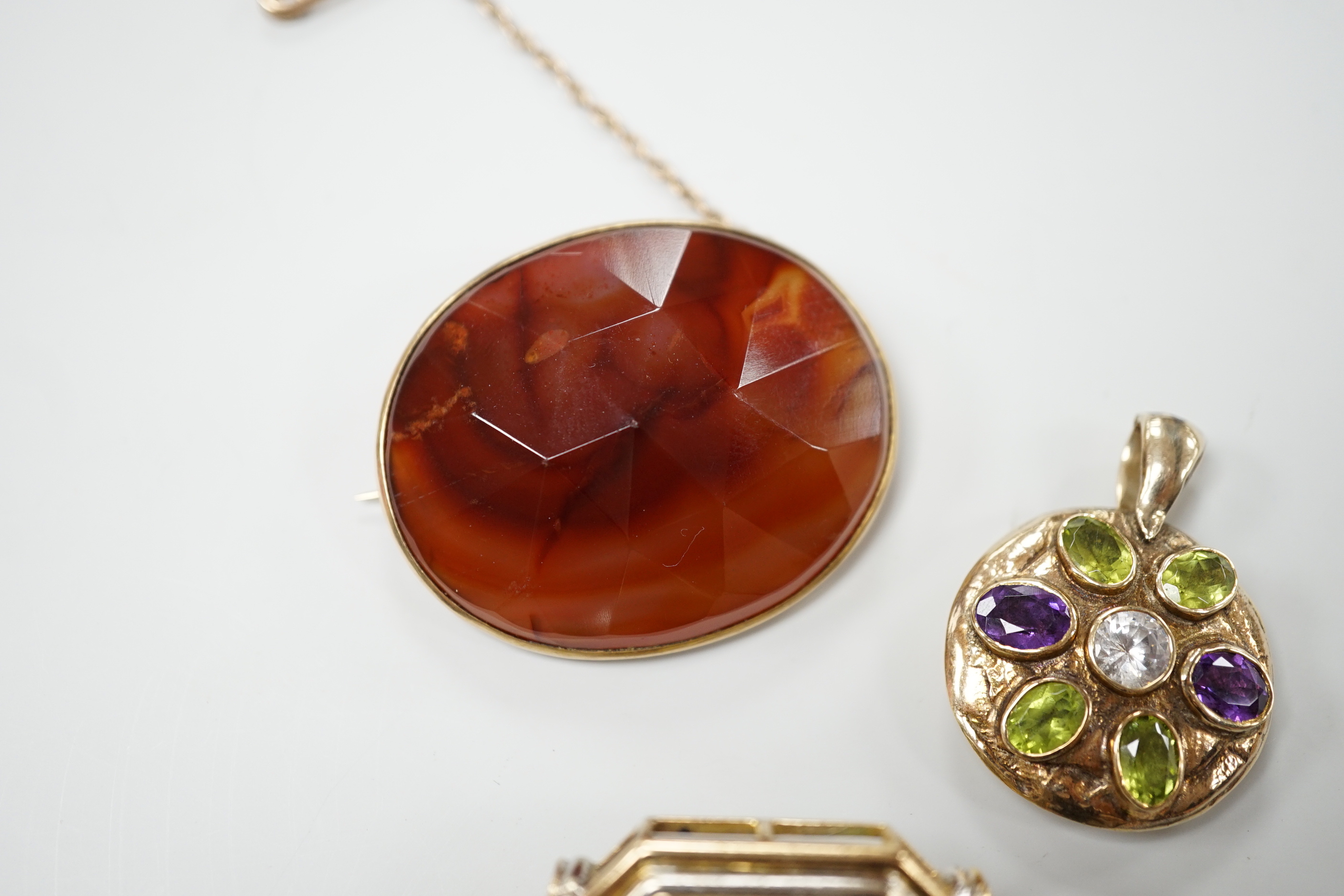 A modern 9ct gold, peridot, amethyst and simulated diamond cluster set circular pendant, diameter 27mm, together with a 9k and citrine set brooch and a yellow metal and facetted agate set brooch.